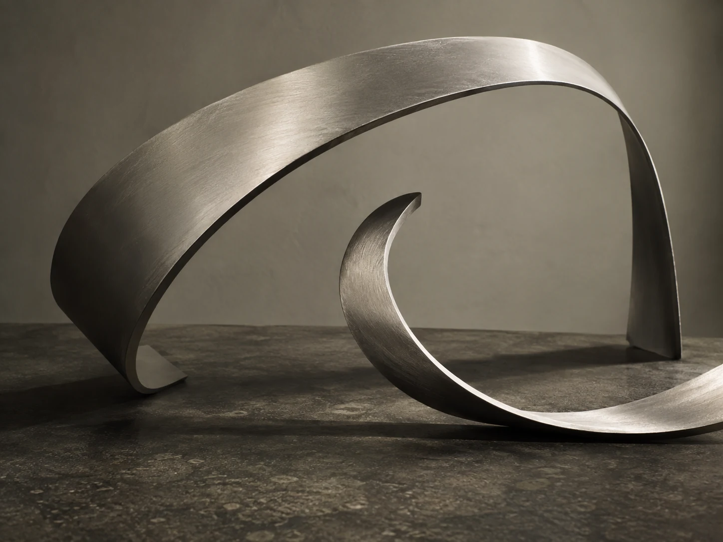 Two distinct metal forms arranged in a balanced composition
